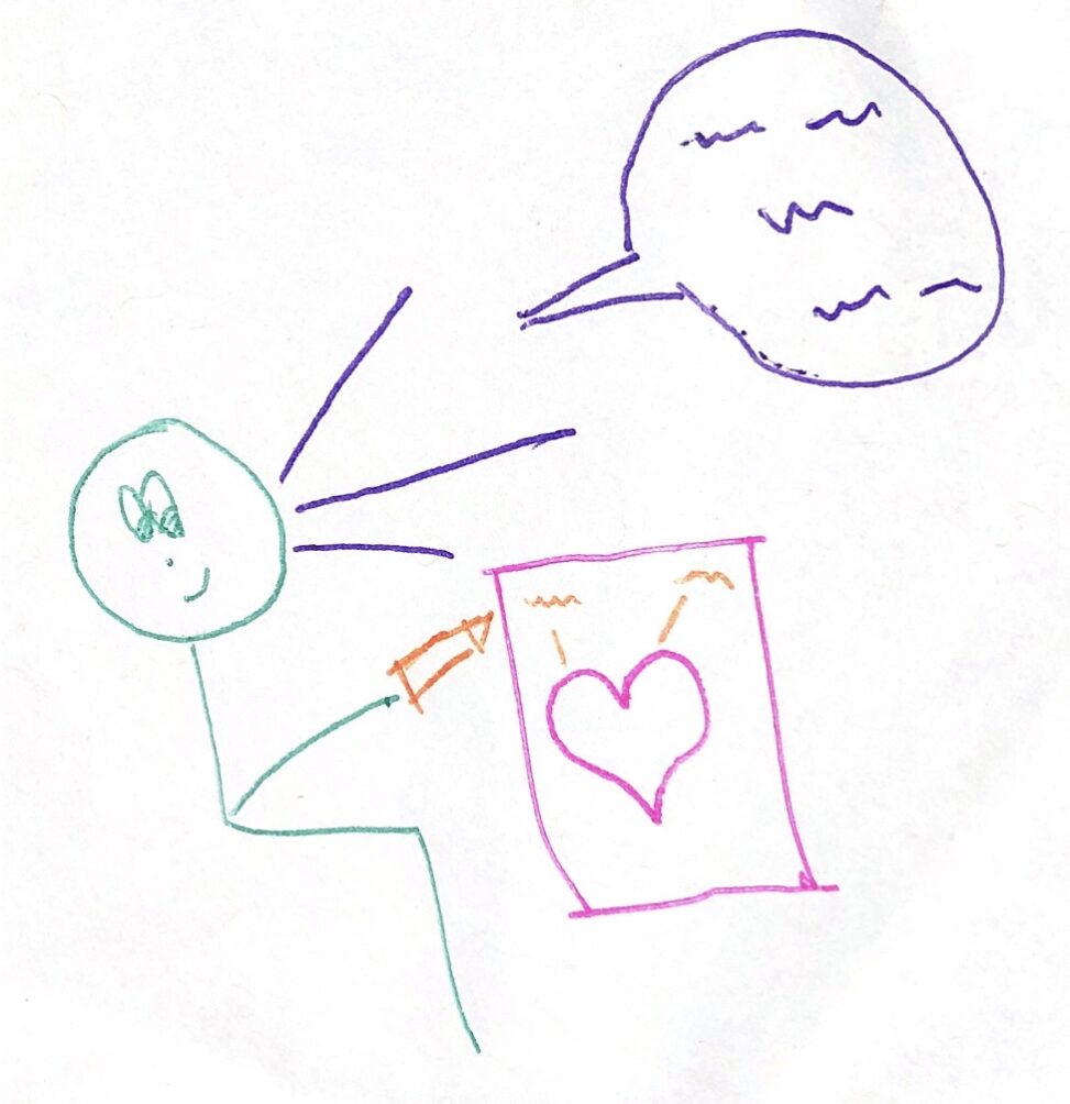 Stick figure character sitting at her desk holding an orange pen. There is a piece of paper with a labelling heart diagram on it. Stick figure is explaining the parts of the heart on a speech text.